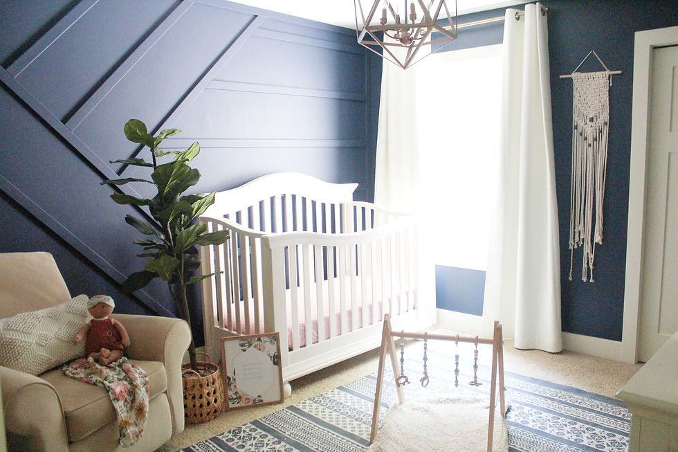 Aria nursery with bold, trimmed out wall and stark white crib and curtains for color contrast