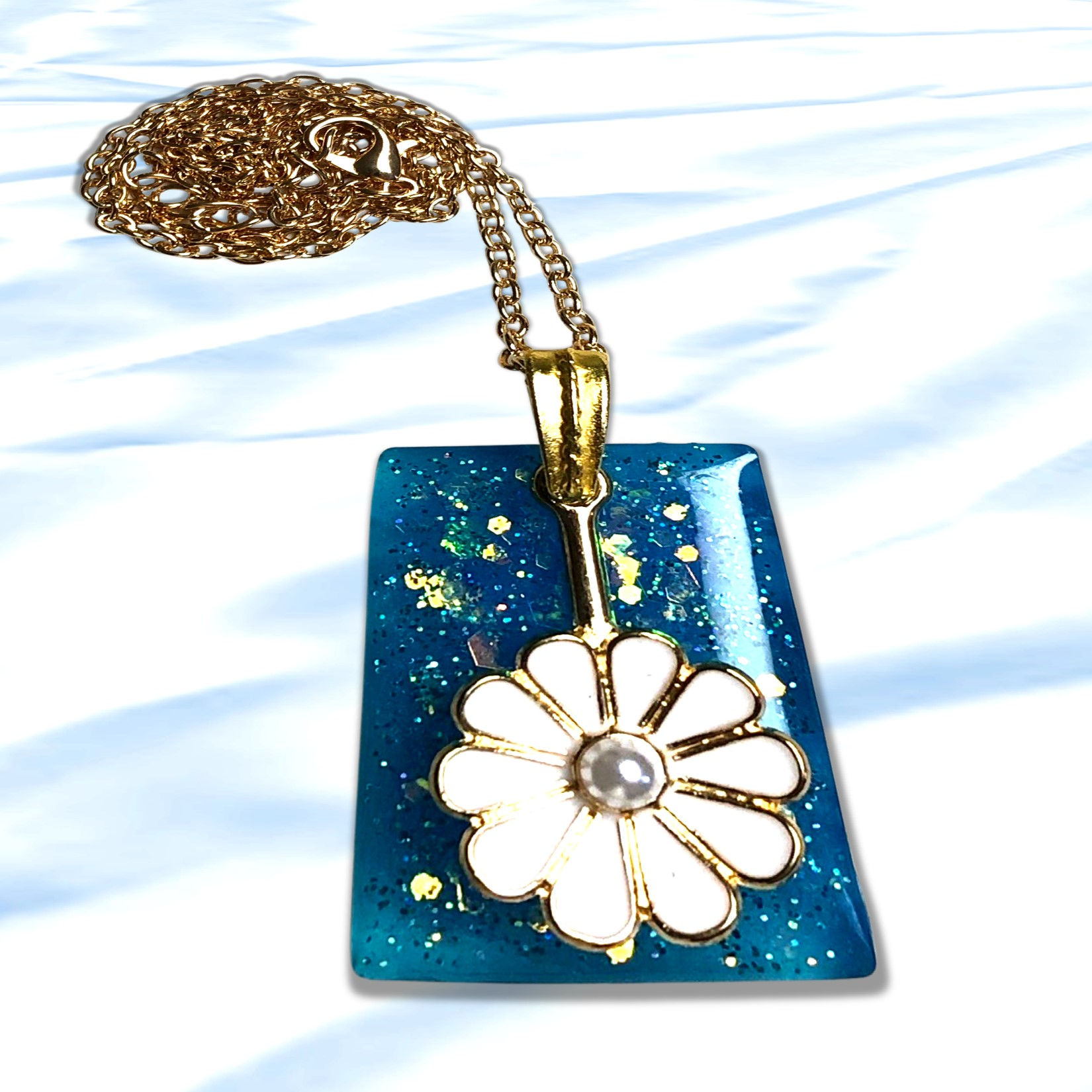 Seaside Waterdrop Resin Pendant Necklace with gold chain on a blue background. KCM Gifts4You