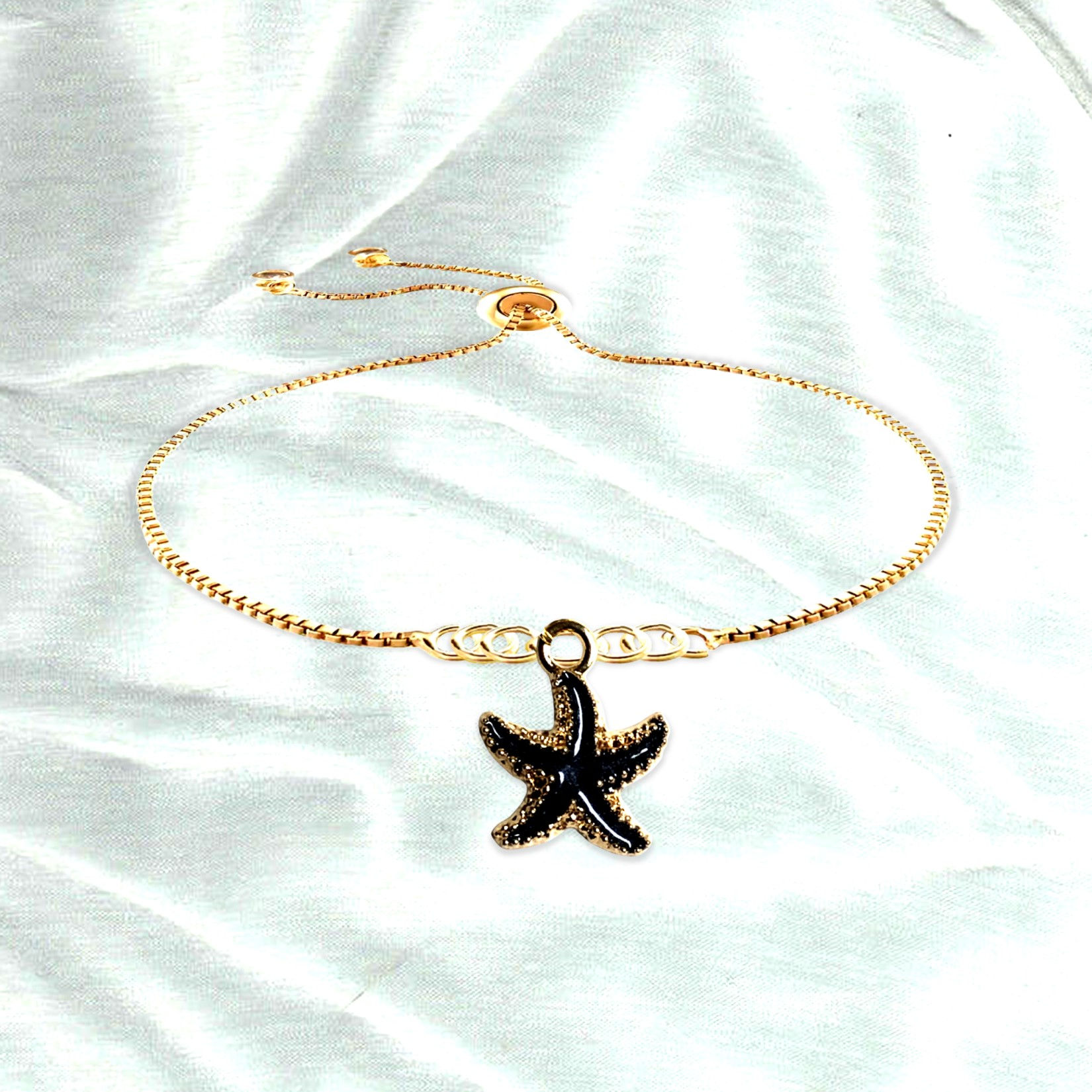 Gold starfish bracelet on white background; Tidal Spark Bracelet KCM Gifts4You