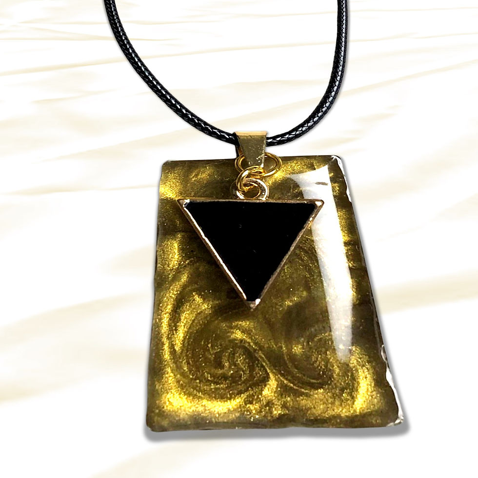 Gold pendant with black triangle design displayed on a white background.