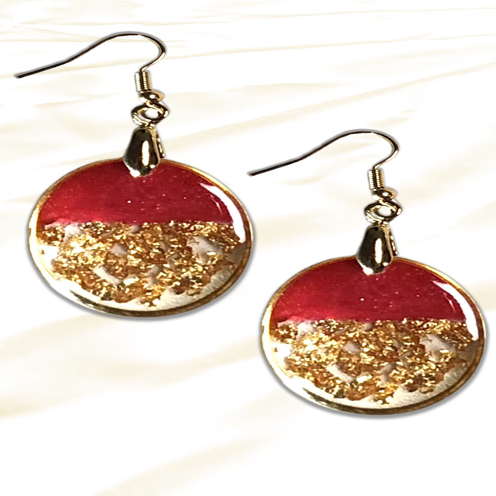 Pair of red and gold dangle earrings; metallic details, beautiful jewelry style.