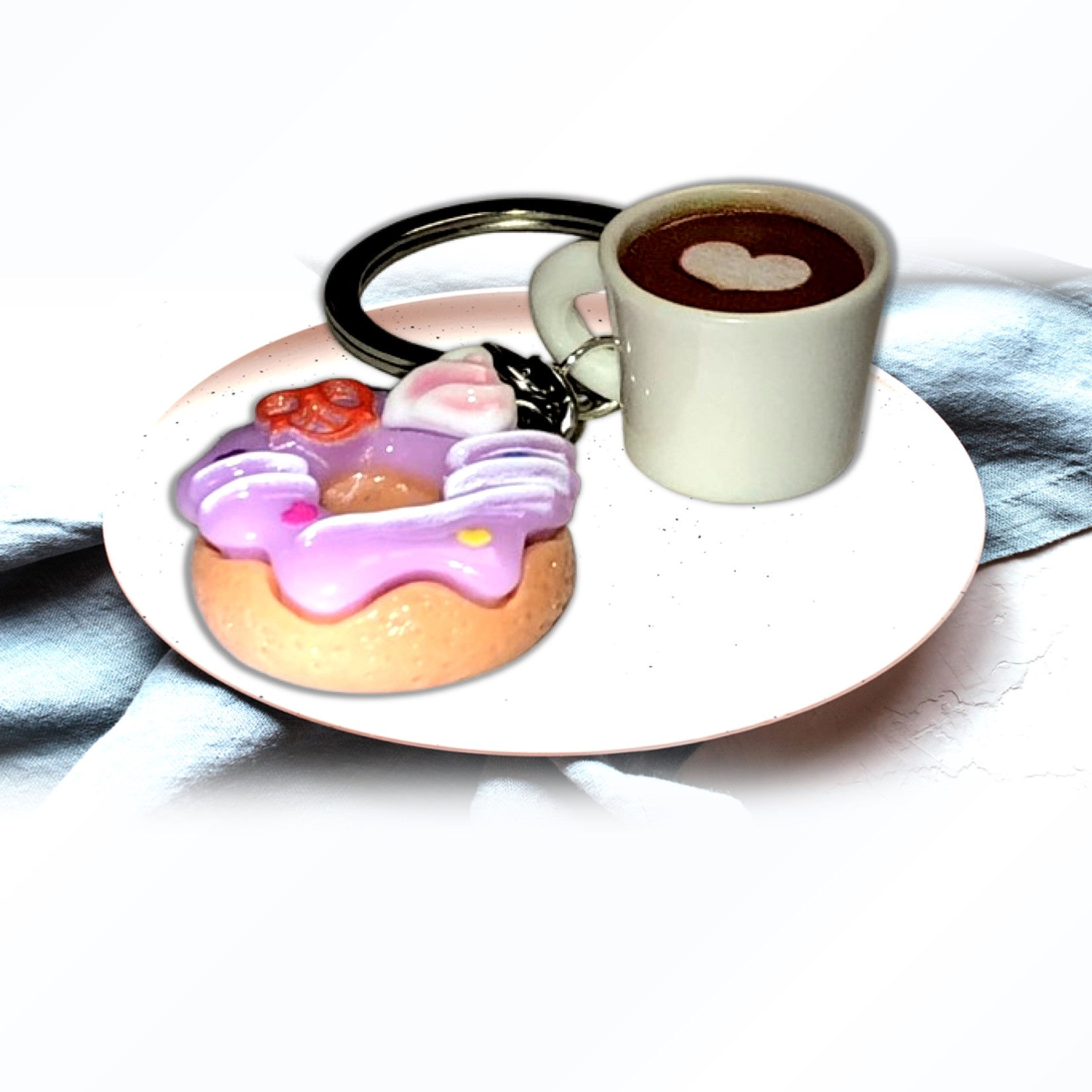 Donut on a plate next to a cup of coffee. KCM Gifts4You