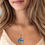 Thumbnail: Young woman wearing Seashell Swirl Pendant Necklace, a fashion statement from KCM Gifts4You.