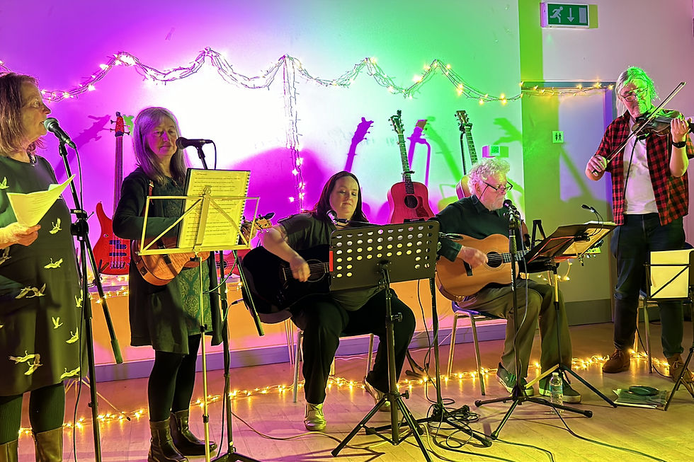 From left to right: Jo, Lindsey, Katy, Kev, and Phil – the Kitchen Table Band performing at the Spring Sing.