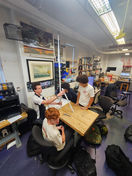 Students study around a table in classroom setting, New York Harbor School.
