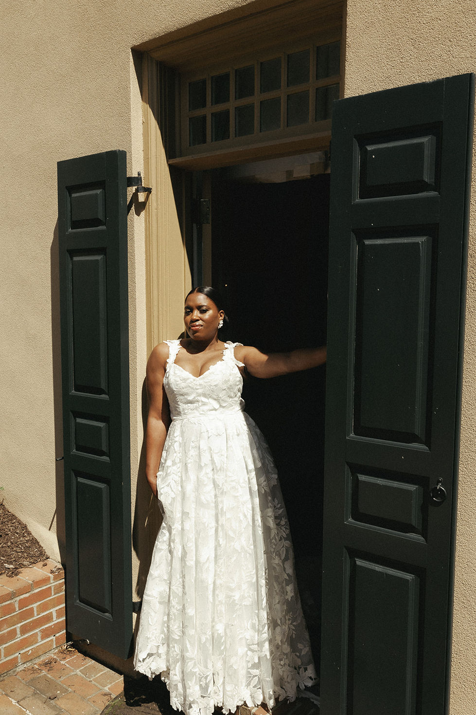 a woman in a white dress is standing in a doorway