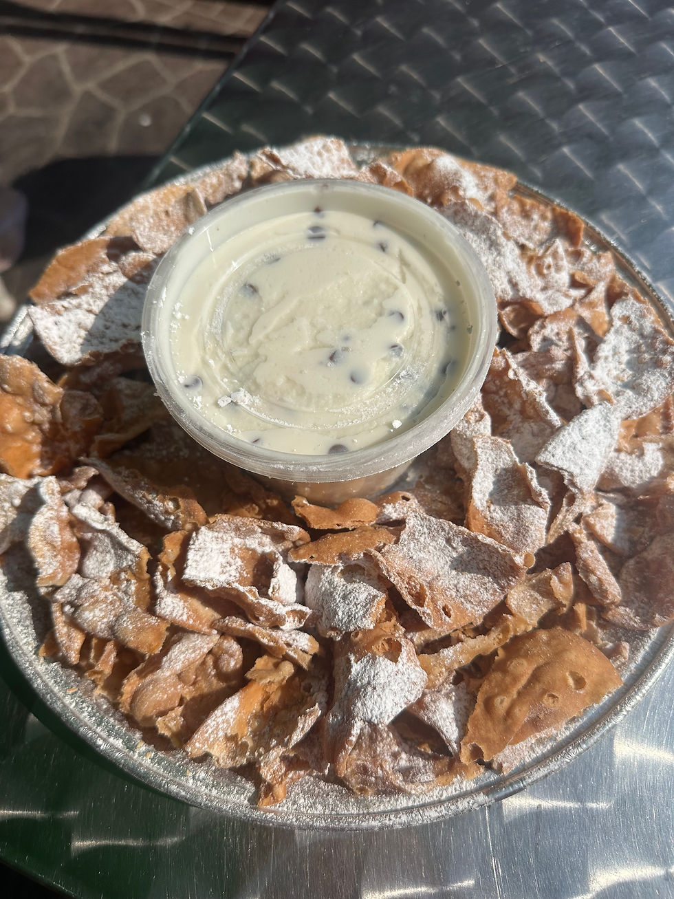 Deconstructed cannoli dip plate with ricotta filling and pastry shells.