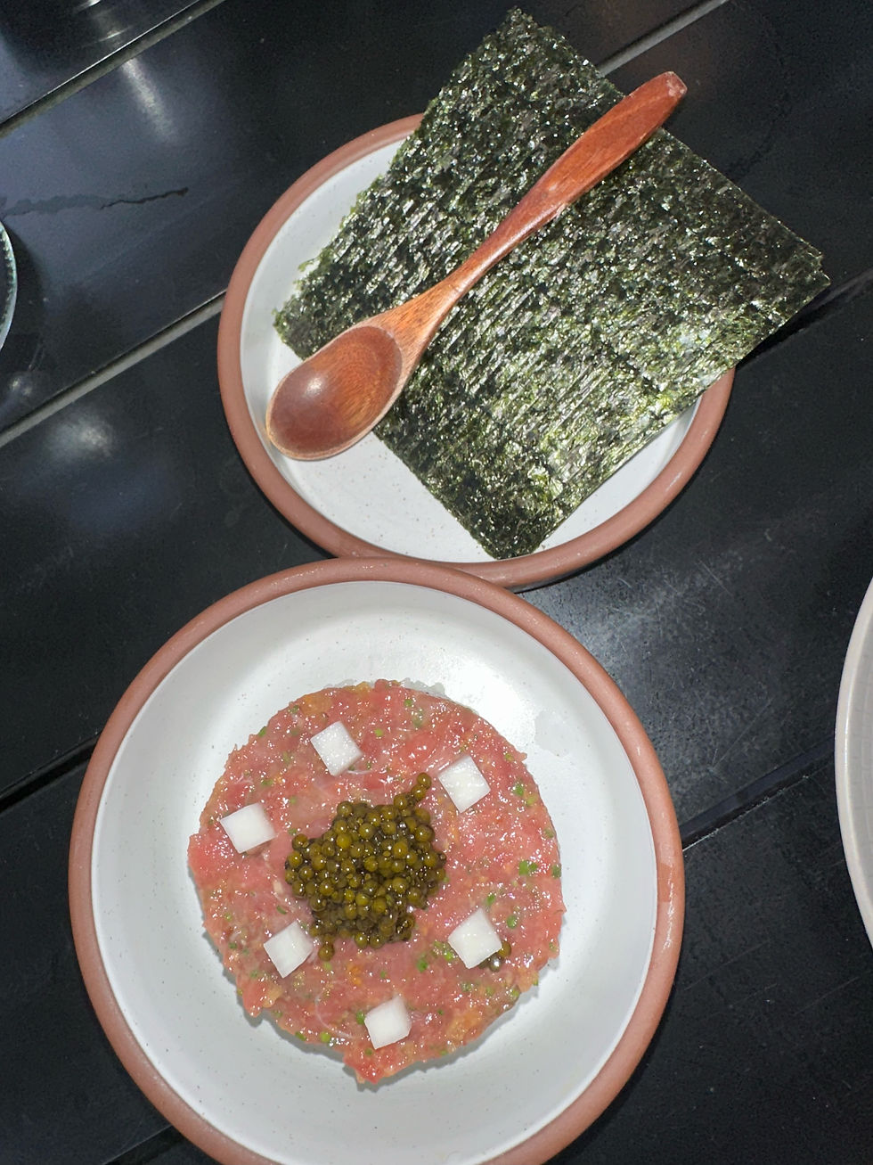 TCD Tuna Toro hand roll with caviar and pickled onion.