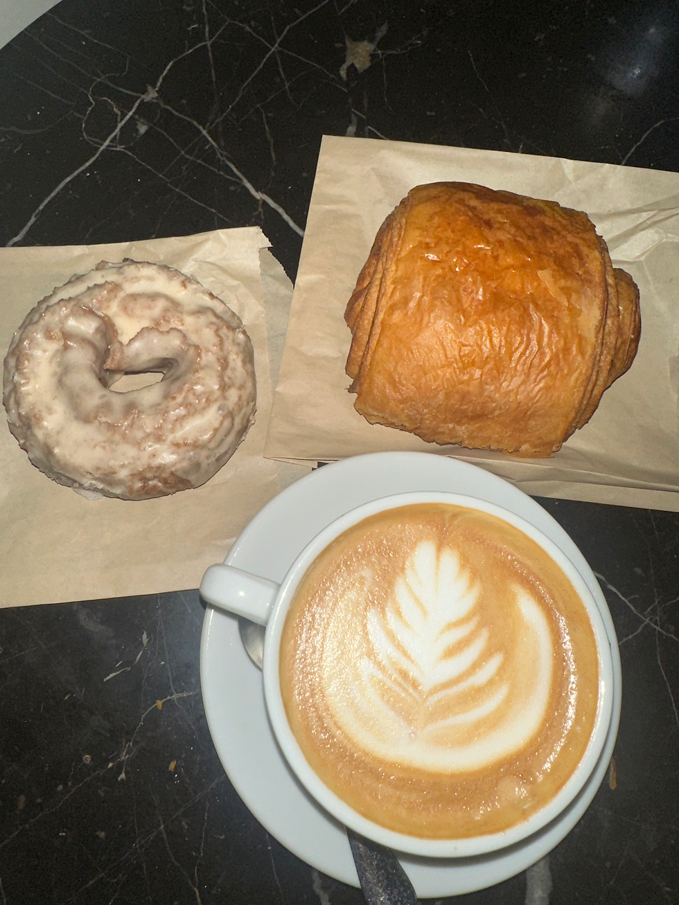 Old-fashioned apple cider donut and flaky chocolate croissant from Caffe Umbria, Chicago, adding to a warm and inviting breakfast experience.