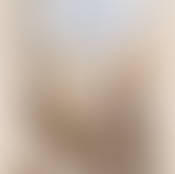 ### Feature Image Alt Text: Walnut brown cascading crochet blanket draped over white chair in cozy farmhouse living room