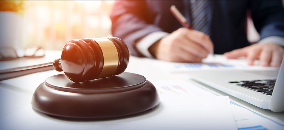 man doing paperwork with gavel in front of him
