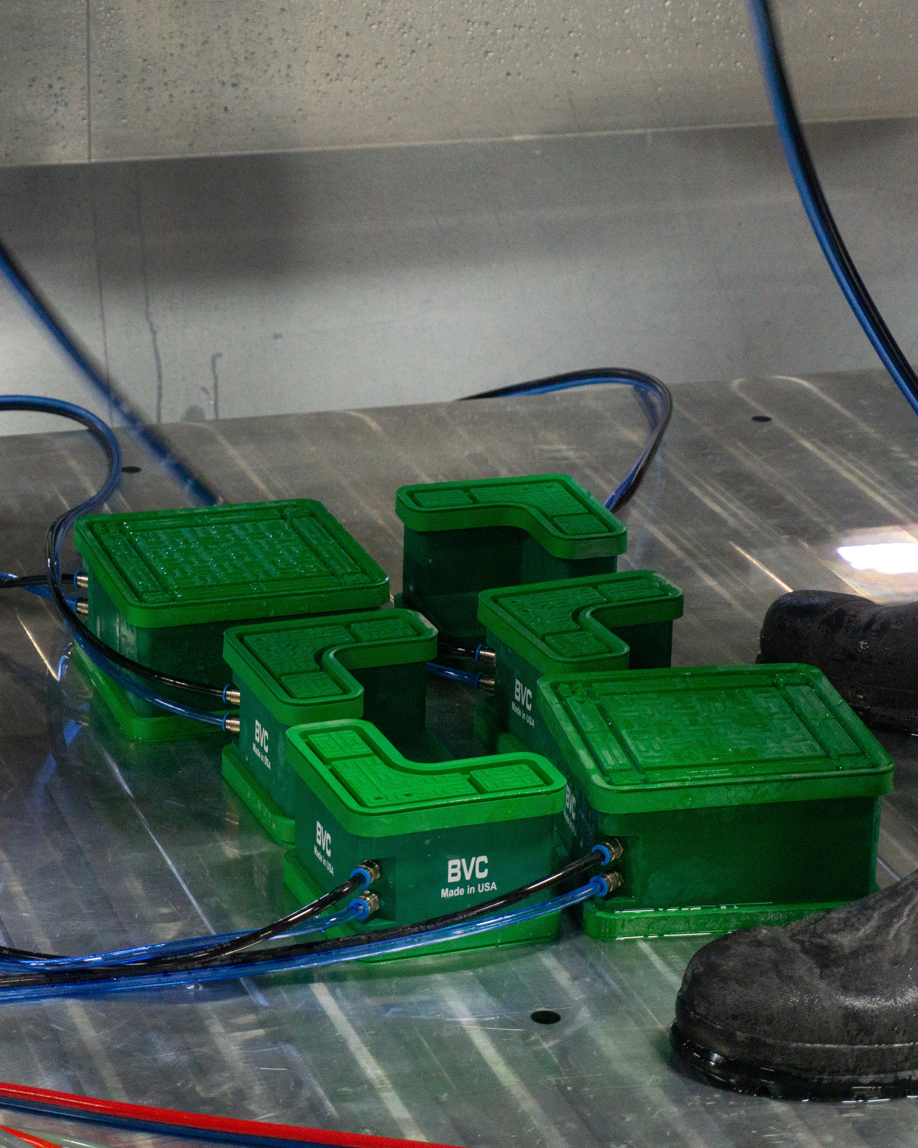 Better Vacuum Cups (BVC) holding a quartz slab as it is placed onto the Paladin CNC stone mill table