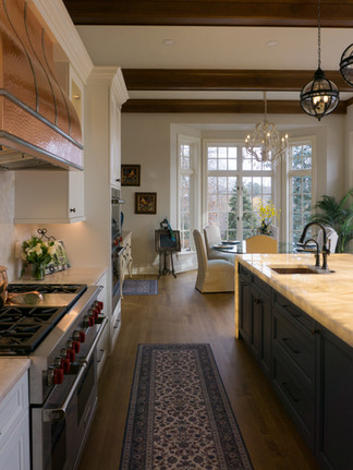 Cristallo Traslux Ultra Quartzite countertops paired with custom cabinetry and full height splash for a refined, timeless kitchen design.