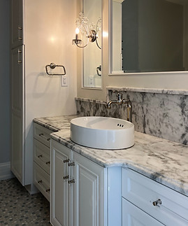 prince white quartzite vanity countertops with custom splash with stone ledge
