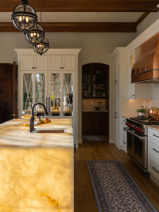 Quartzite countertops featuring Cristallo Traslux Ultra Quartzite with a dramatic backlit island as the focal point.