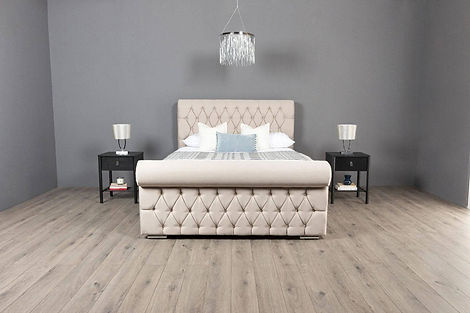 Luxurious bedroom with a tufted cream headboard, plaid pillows, and a plush fur blanket.