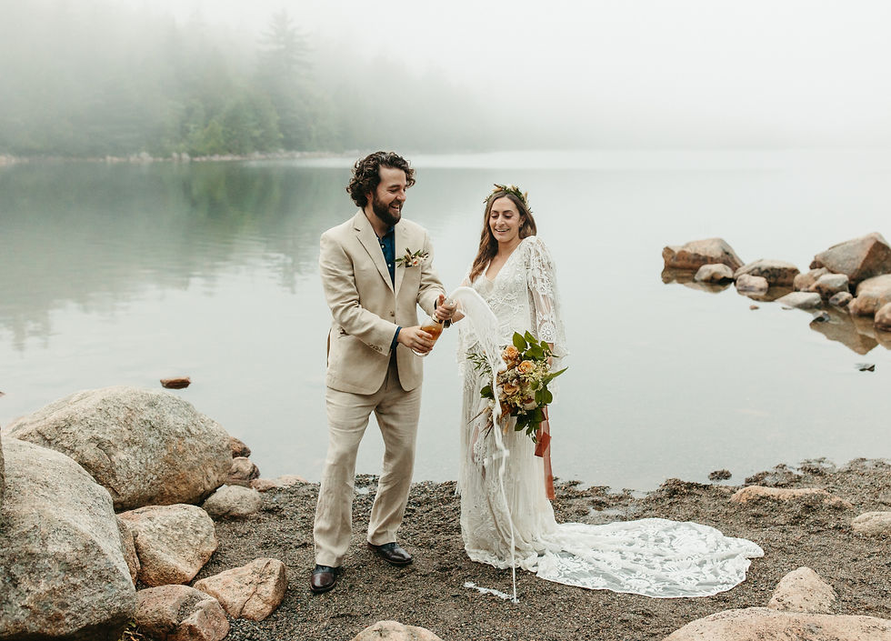 A bride and groom celebrate their elopement on Jordan Pond at Acadia National Park in Maine.