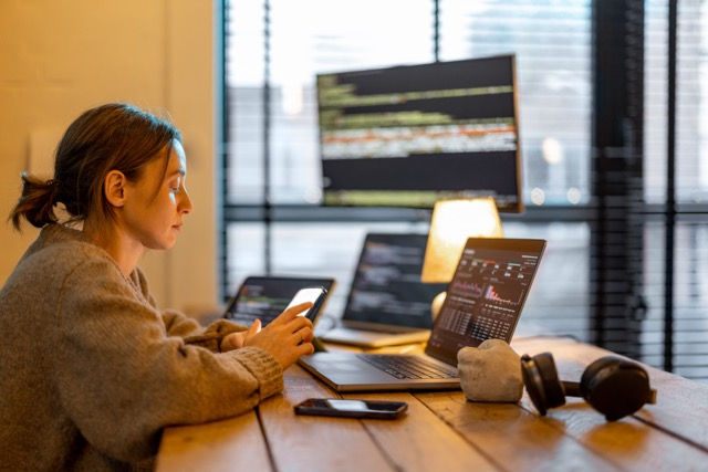 Person multitasking with multiple devices.