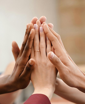 Many hands come together in a group high five.