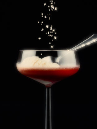 Vanilla ice cream in a cocktail glass with lingari and salt spritzing on it