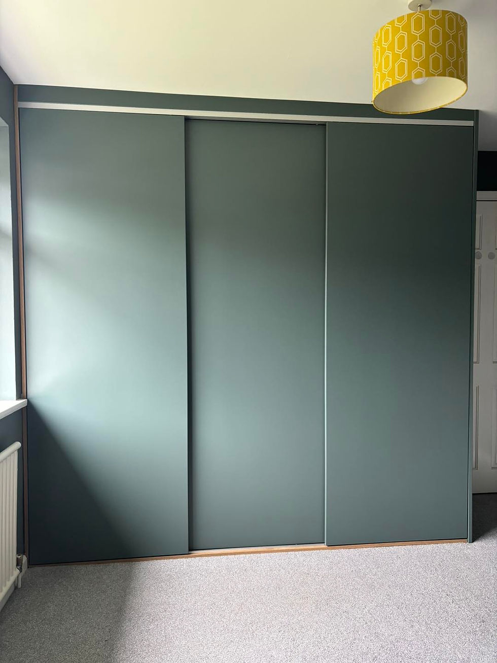 Sliding wardrobe spray finished in Lick Green closed.