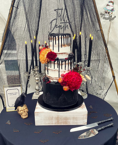 gothic black and white wedding cake with fresh flowers