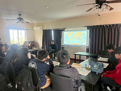 Students watching a multimedia classroom presentation at DA·VINCI International School