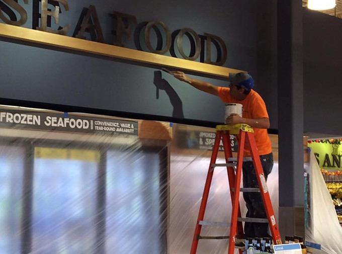 Commercial painter completing a retail store interior painting project in Miami, FL. Professional commercial painting by All Florida Colors Painting.