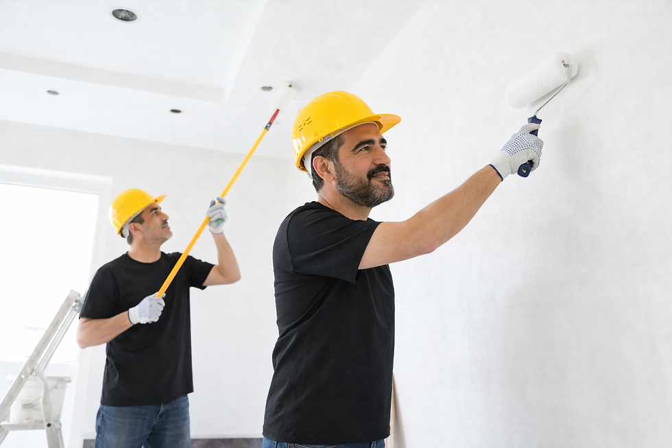 Eye-level view of a professional painter applying paint to a living room wall