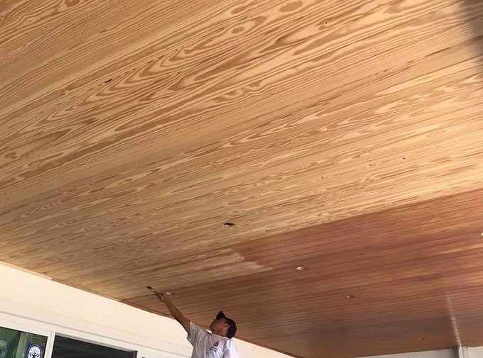 Professional painter staining a luxury wood ceiling on a custom home in Palm Beach, FL. Premium residential wood finishing by All Florida Colors Painting.