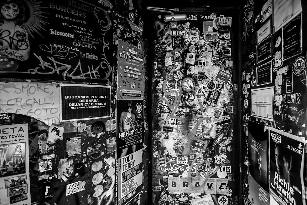 Grungy wall covered in punk stickers, flyers, and graffiti—capturing the raw, rebellious spirit of DIY marketing and creative independence.