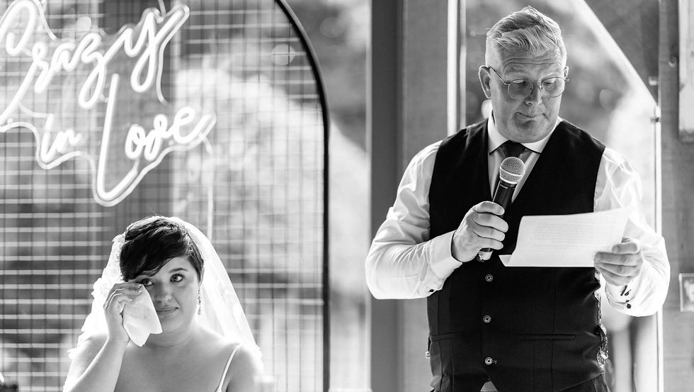 Emotional wedding toast during a luxury reception as guests react to a meaningful speech that creates lasting wedding memories.