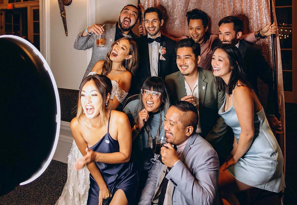 Wedding guests laughing together at a photo booth