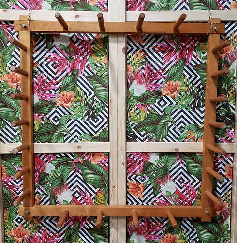 A hanging warping board (square wooden frame with 22 pegs sticking out from the frame).