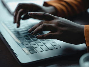A Person Typing on a Keyboard