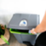 Someone using the foot pedal to open the bin and put waste inside