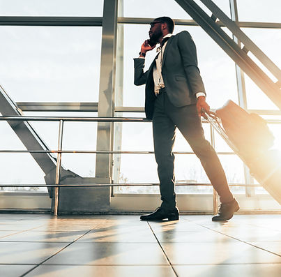 african-american-man-suit-with-luggage-making-call-outside-airport-setting-is-busy.jpg