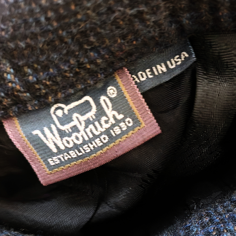 Thumbnail: Woolrich tag with logo and text establishing it, made in USA.