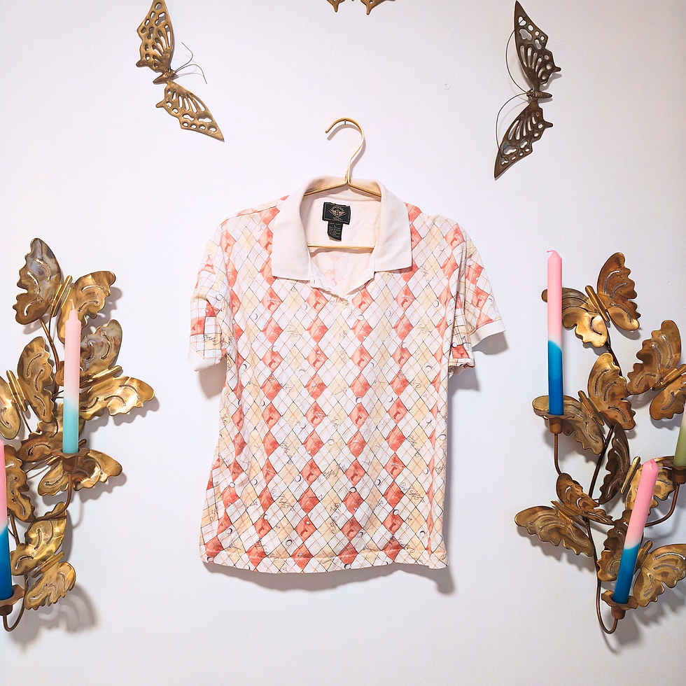 Thumbnail: White and peach patterned polo hanging on a white wall with decorations.