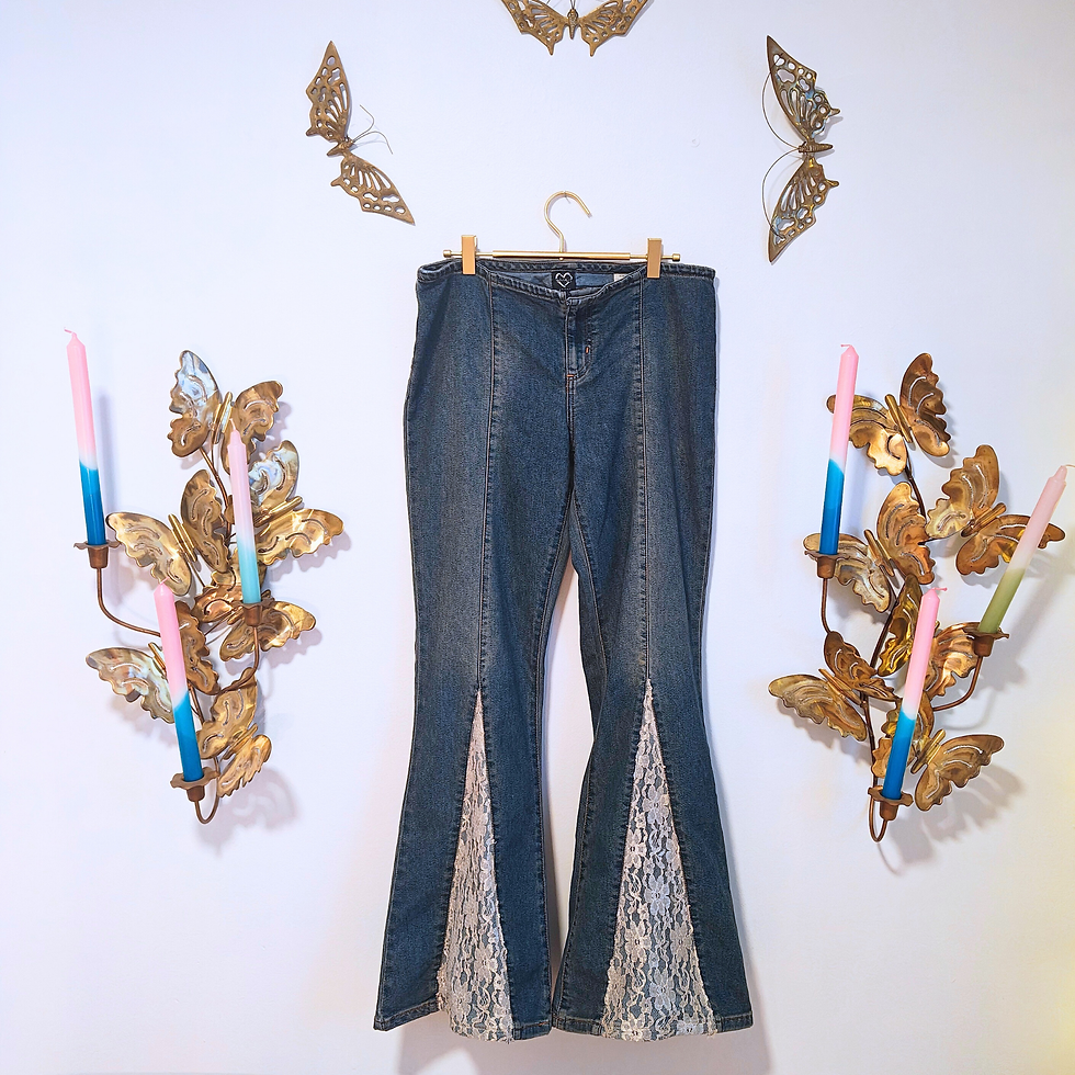 Thumbnail: Blue jeans hanging on a wall with butterfly decor and other items.