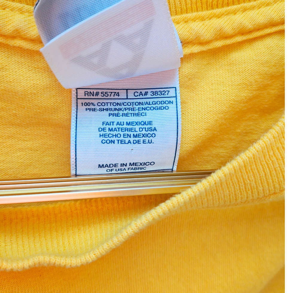 Thumbnail: Yellow t-shirt tag with printed text; made in Mexico with cotton fabric.