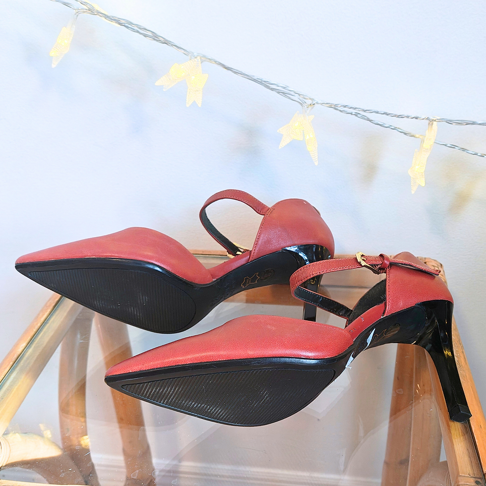 Thumbnail: Pair of red heeled shoes on a chair with a pointed toe and strap.