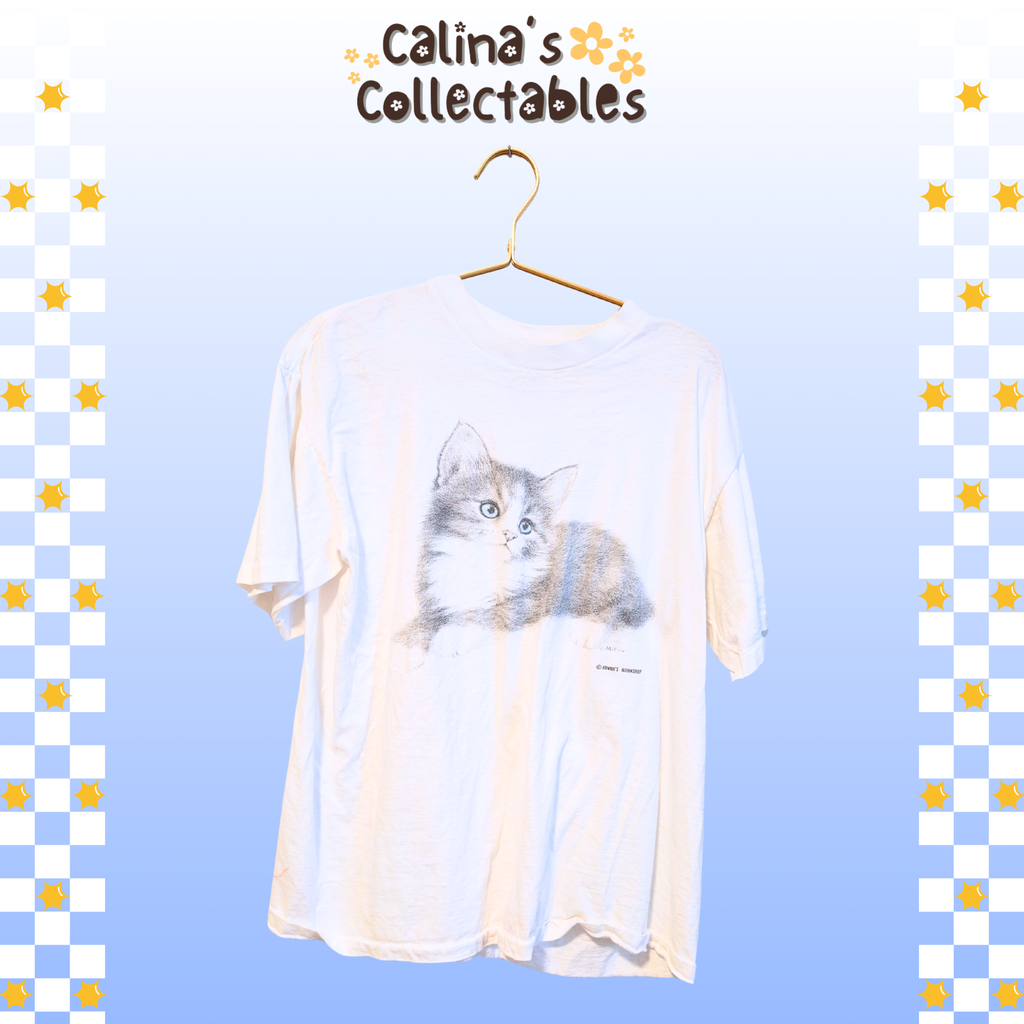 White t-shirt with cat graphic; Calina's Collectables brand on display.