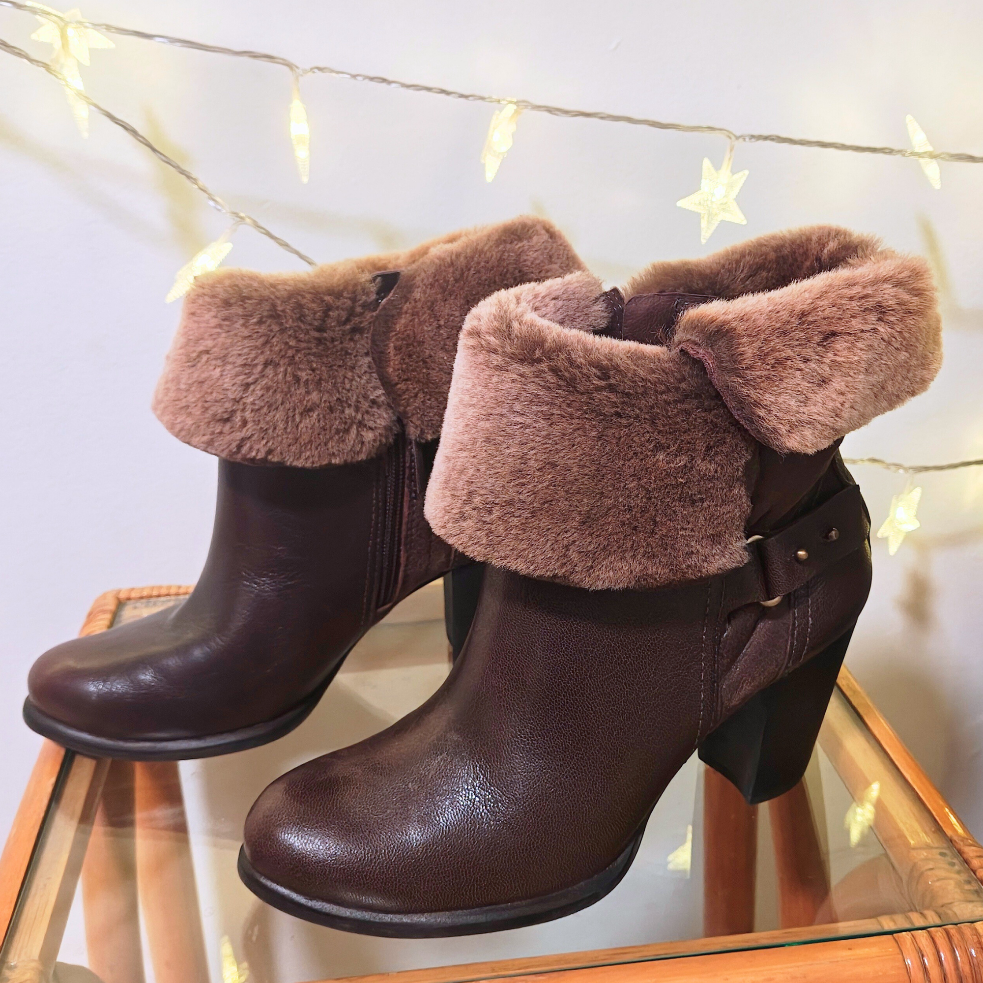 Pair of brown leather boots with fur trim, perfect for cold weather.