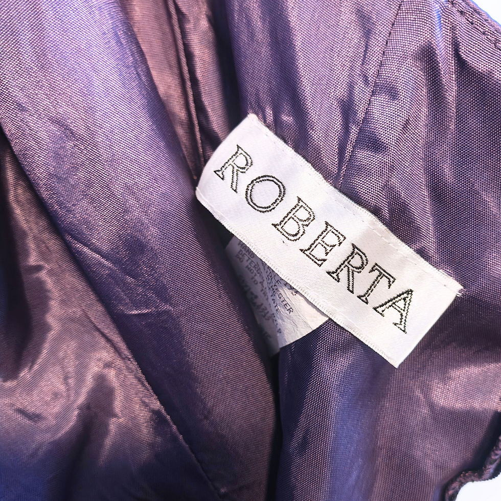 Thumbnail: Close-up of a label inside a purple garment that reads ROBERTA