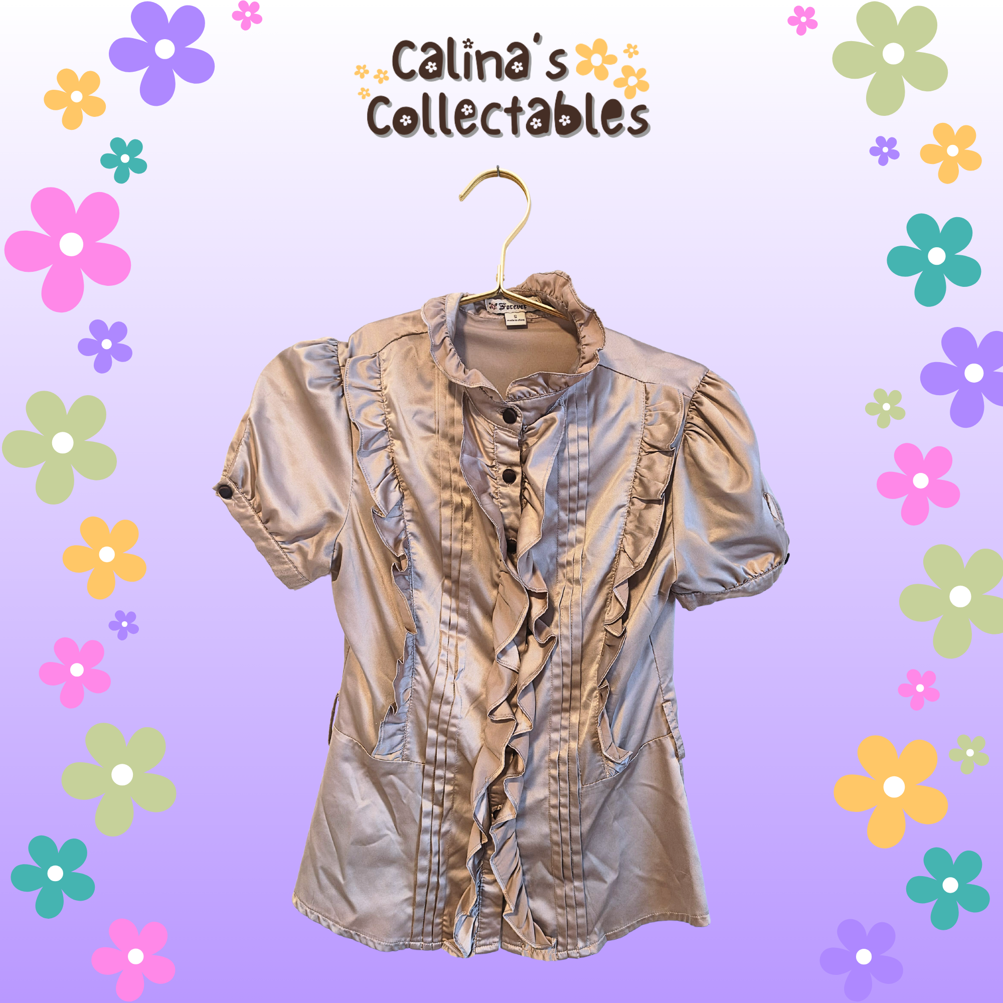 Beige shirt on a hanger with "Calina's Collectables" background and flowers.