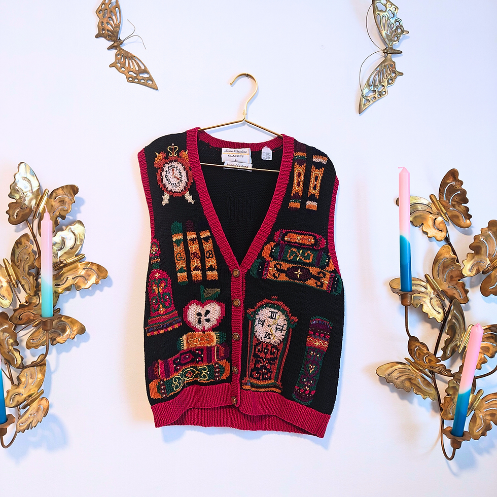 Thumbnail: Black vest with colorful school designs hanging on a white wall background.