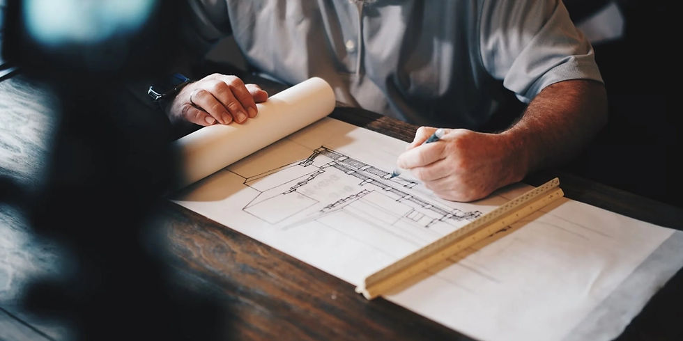 Hands reviewing blueprints for preconstruction services