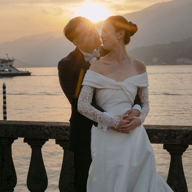 Wedding couple embracing by Lake Como during golden hour
