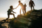 Group of hikers on a mountain. Woman hel